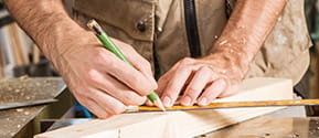Craftsman drawing a line with a rule
