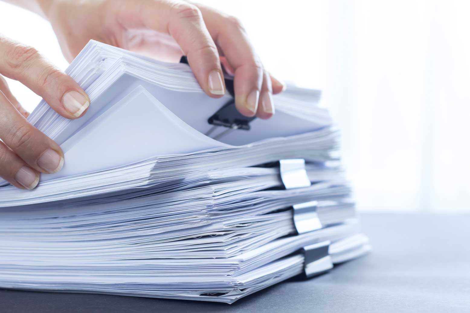 hands sorting through papers