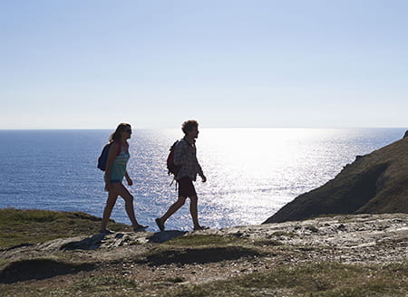 Hikers by coastline