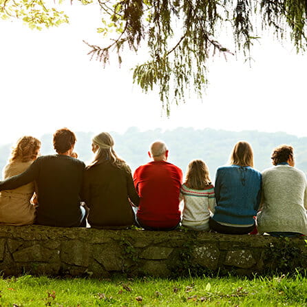 Multi-generation family relaxing on wall