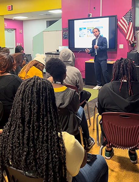 Jordan teaching a financial literacy course at Norland Senior High School