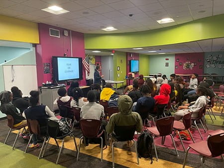 Jordan teaching a financial literacy course at Norland Senior High School