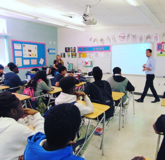 Jordan presenting at the North Miami Middle School during a financial literacy event to a class of 8th graders