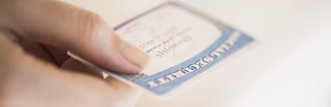 Hand holding social security card.