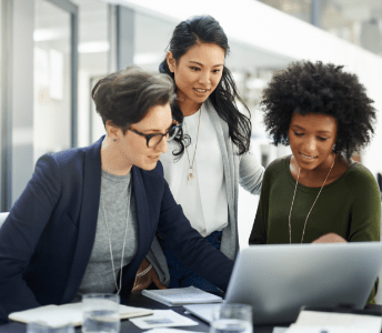 Business professionals gathered around a computer